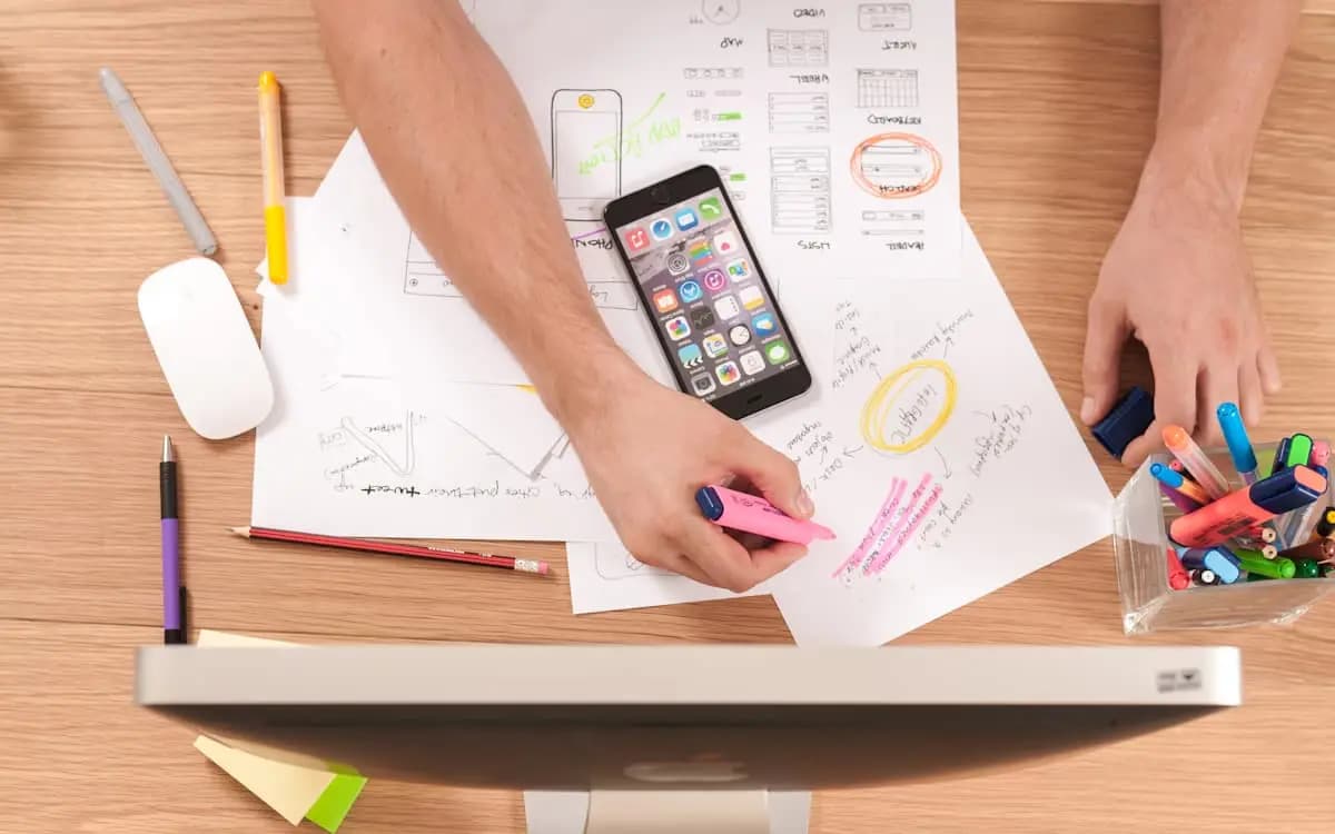 Organized workspace with notes and devices for managing VICIdial lead sheets and reports